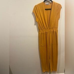 FP Beach gold jumpsuit with plunge neckline